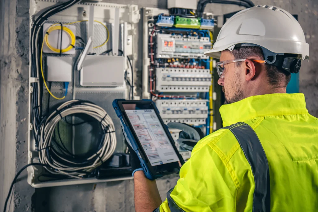 Electrical technician performing Megger insulation resistance testing on industrial equipment in Aziziyah